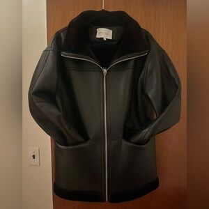 Soft leather with fur lined through out. Can turn cuffs up to show fur